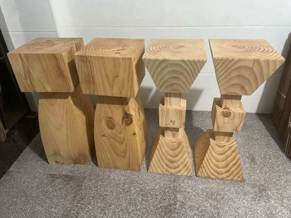 Set of 4 natural solid wood kitchen stools with unique rustic designs.